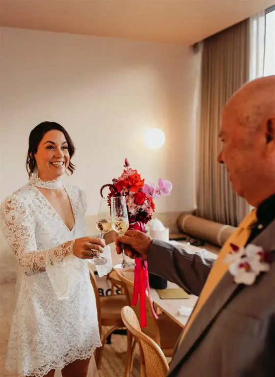 Intimate ceremony setting at The Calile's indoor terrace, with family members seated in a semicircle as rain falls gently outside the floor-to-ceiling windows