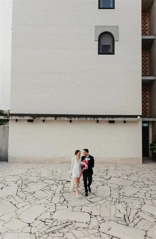 Detail shot of the minimal yet elegant florals by Lilac Green complementing The Calile's modernist peach and pistachio color palette